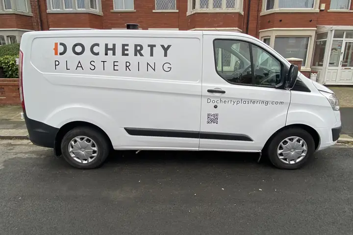 The signwritten Docherty Plastering van parked on a residential street in front of a red-brick bay-fronted terrace.